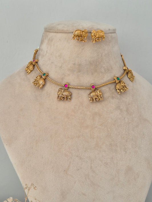 Upama gold necklace set with elephant motif charms and matching earrings