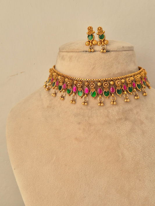 Gold-toned ethnic necklace and matching earrings with green and pink stone embellishments