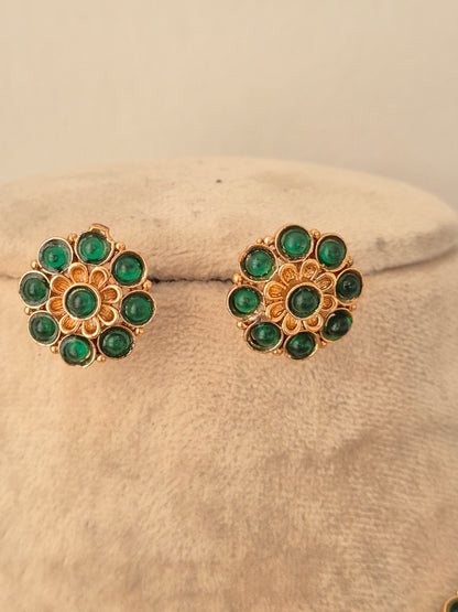 Gold-toned circular floral stud earrings with green stone embellishments from the Gaurika necklace set