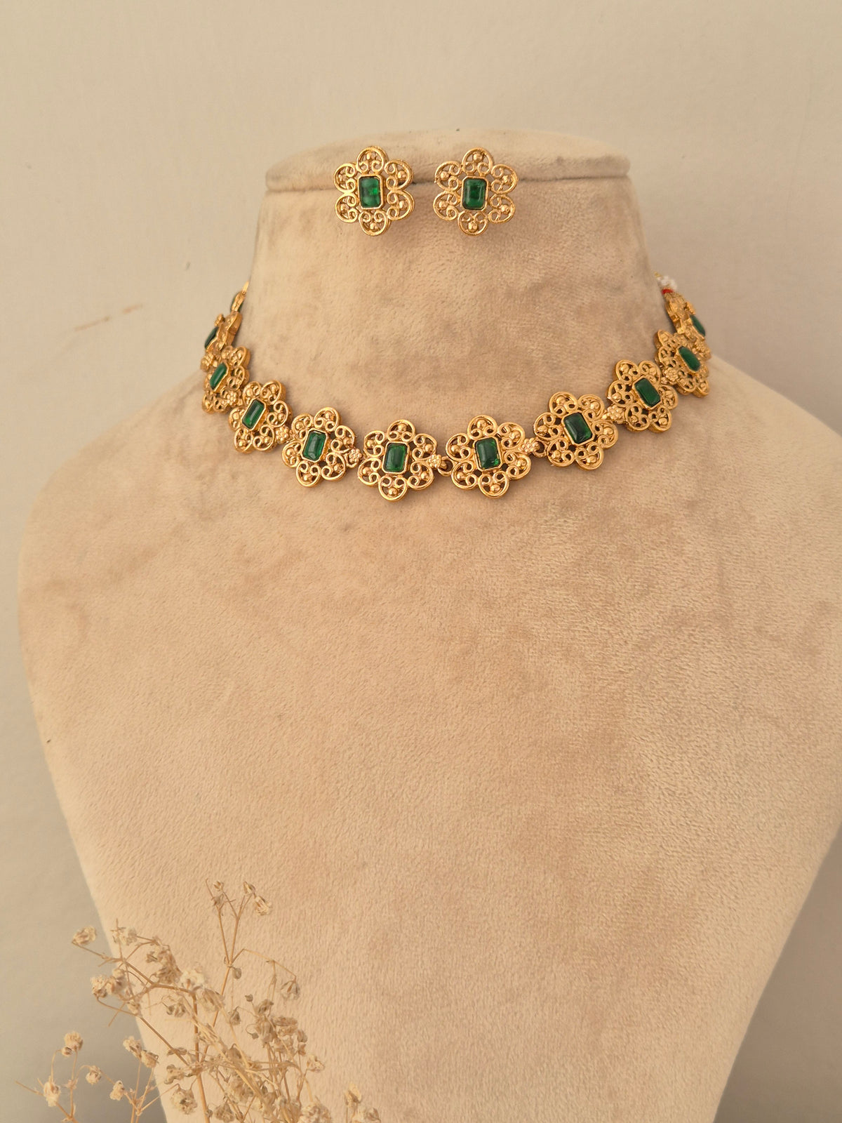 Naitri Umrah Necklace Set crafted in gold-toned brass alloy with green stone floral accents