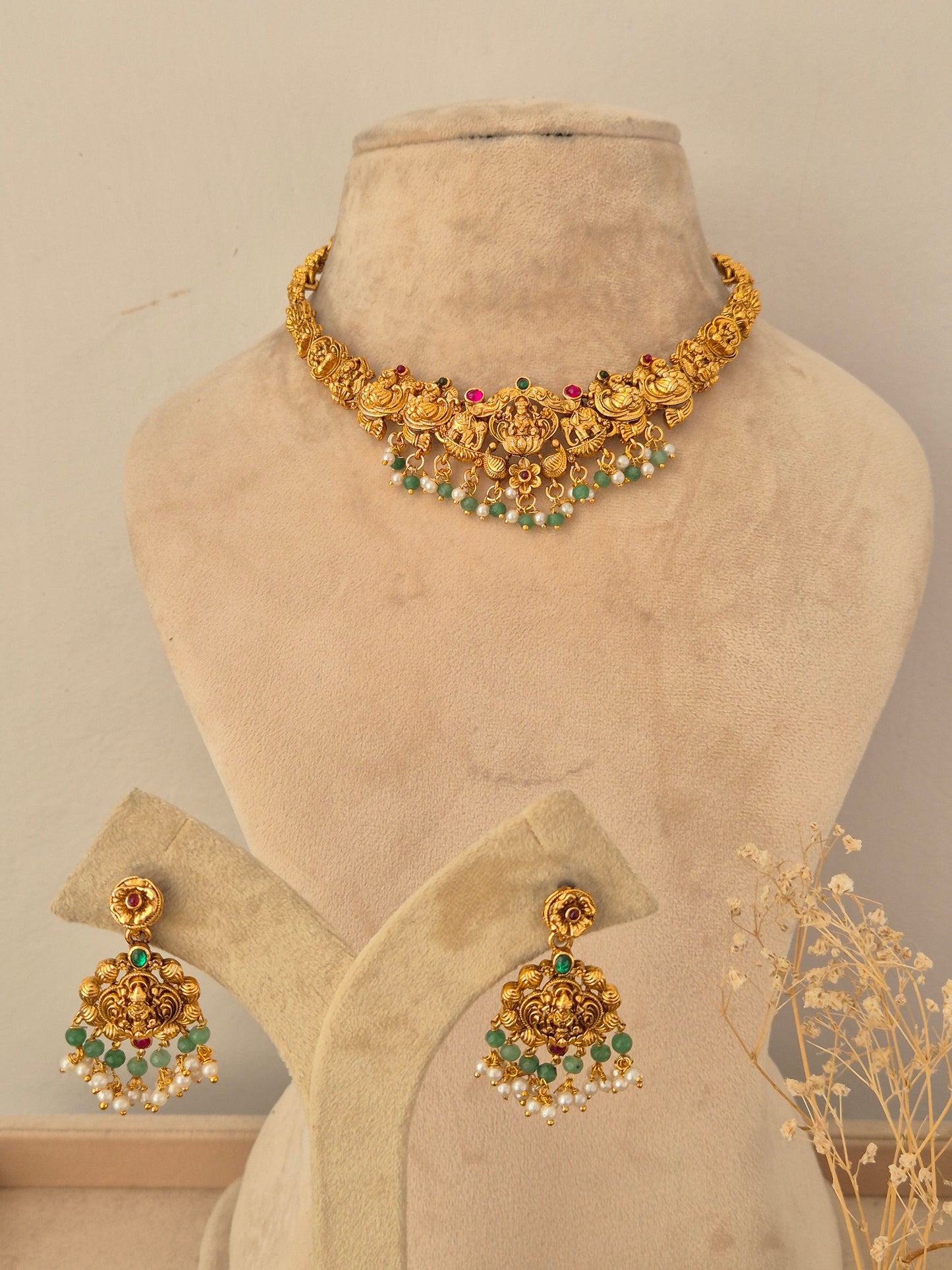 Descriptive & SEO-focused: Antique gold-toned Waraya choker necklace set featuring Goddess Lakshmi motifs with dangling green beads and pearl accents