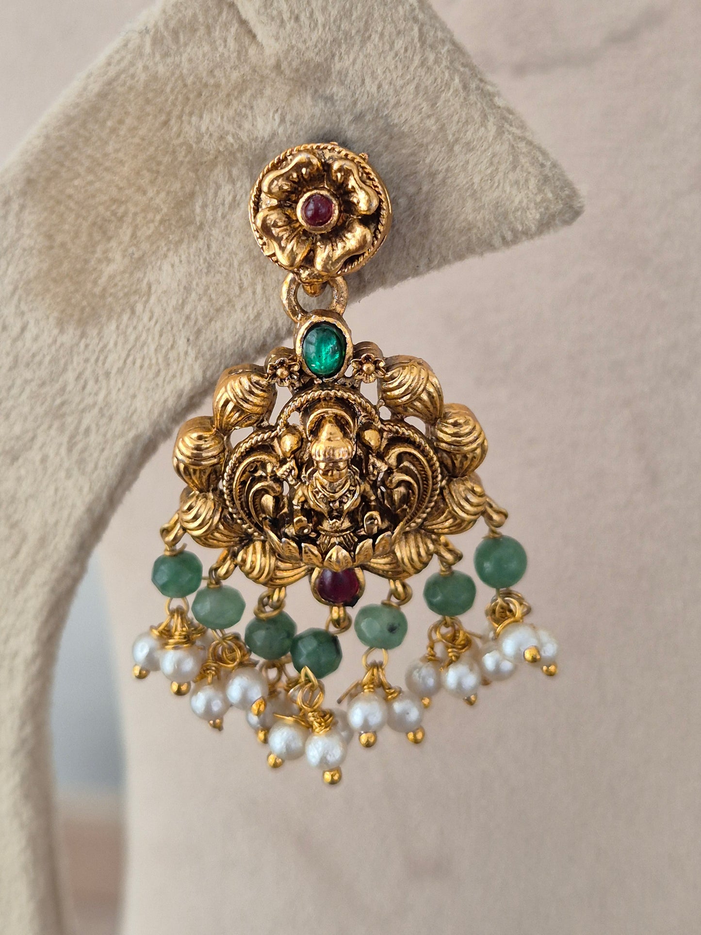 Naitri Waraya Collection matching gold-tone temple earring with deity motif and green stone
