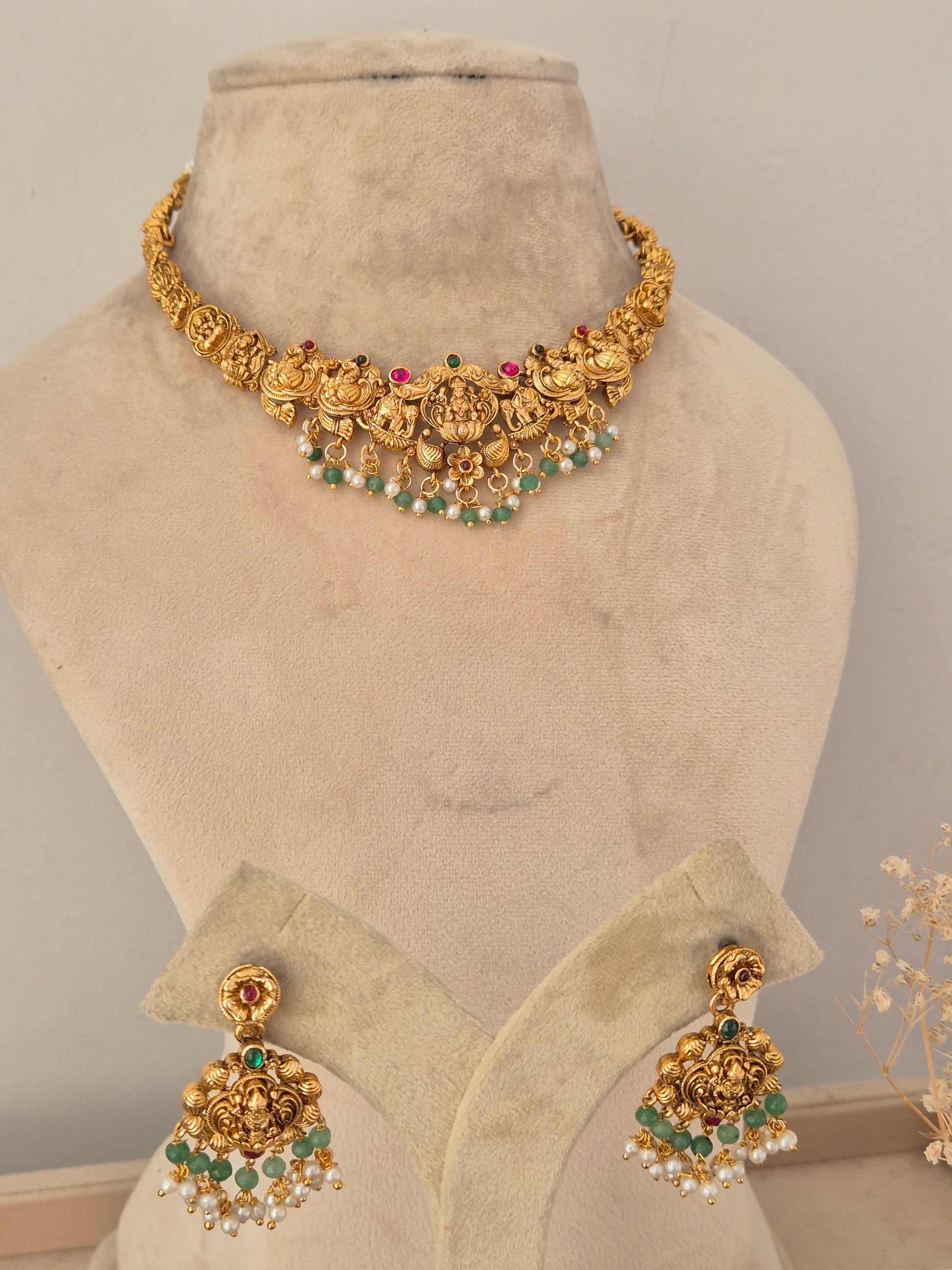 Ethnic temple-style gold choker necklace and matching dangle earrings with green bead drops