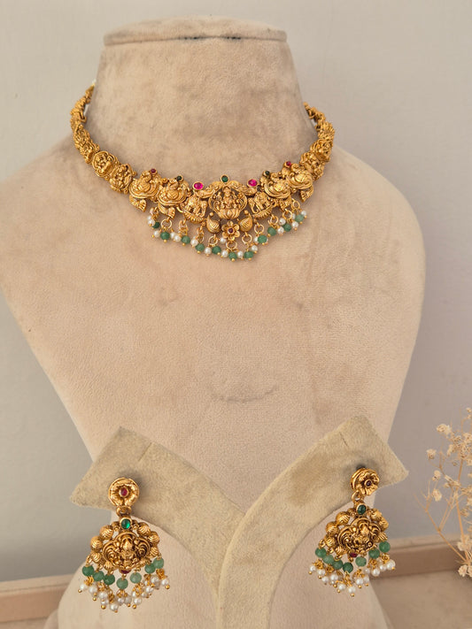Ethnic temple-style gold choker necklace and matching dangle earrings with green bead drops