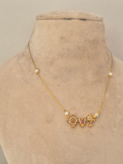 Fine, barely-visible gold chain necklace adorned with three small gold charms centered with pink stones and clear crystals, flanked by small white pearl beads on a display stand