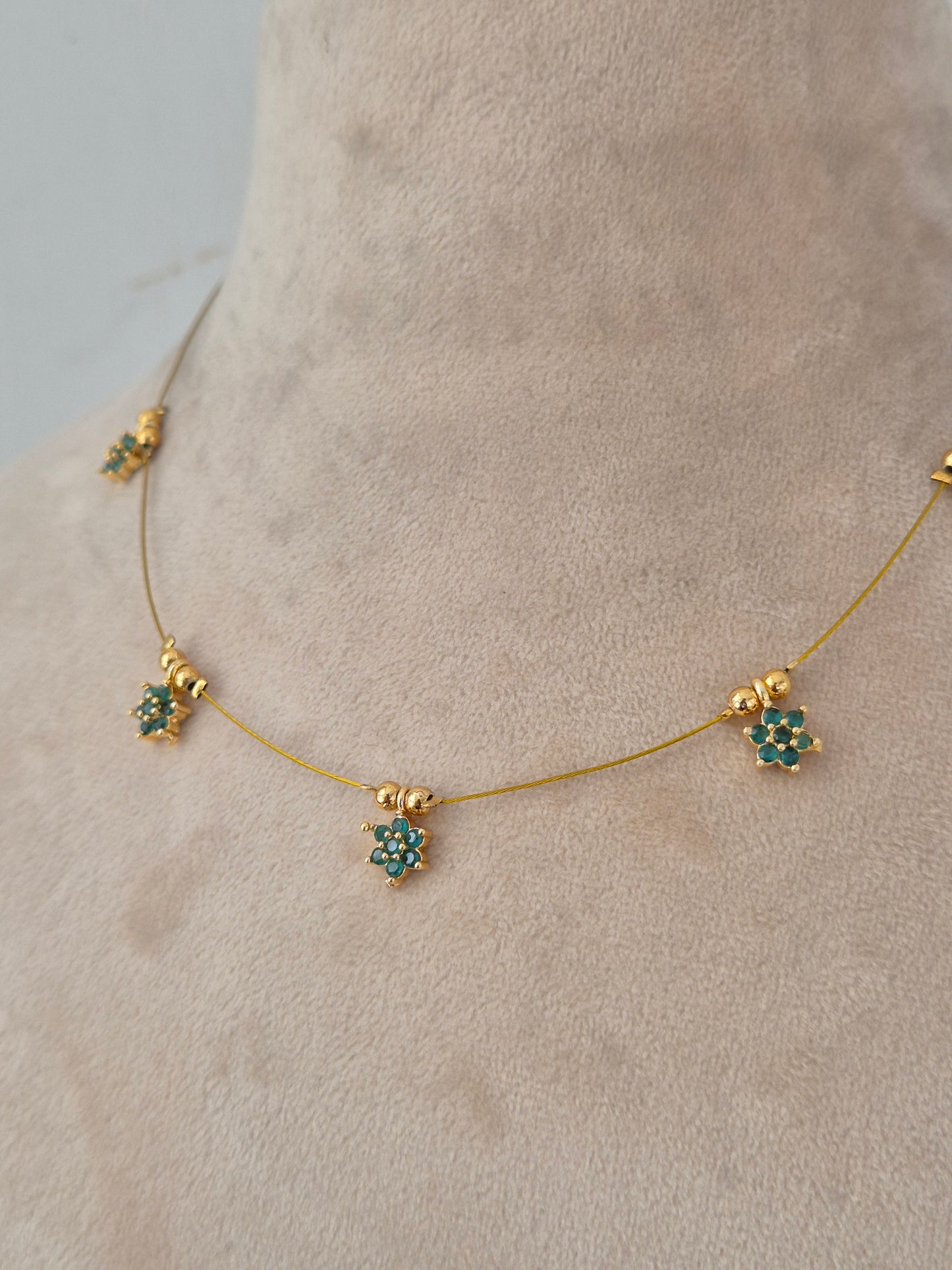 Minimalist gold invisible chain necklace set with green floral stone charms