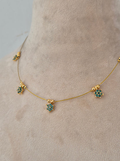 Minimalist gold invisible chain necklace set with green floral stone charms