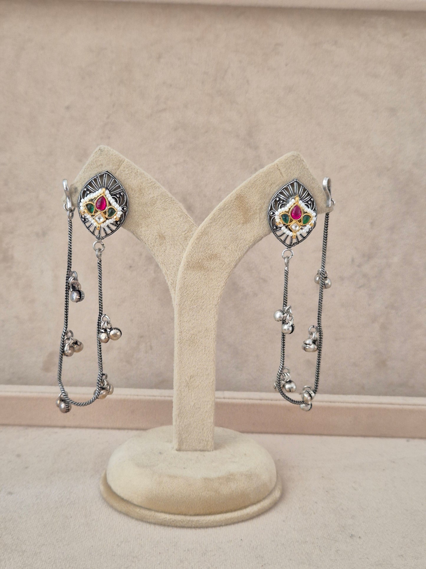 Handcrafted oxidized silver-toned dangle earrings featuring enamel stone studs and long hanging silver chain tassels with ghungroo beads