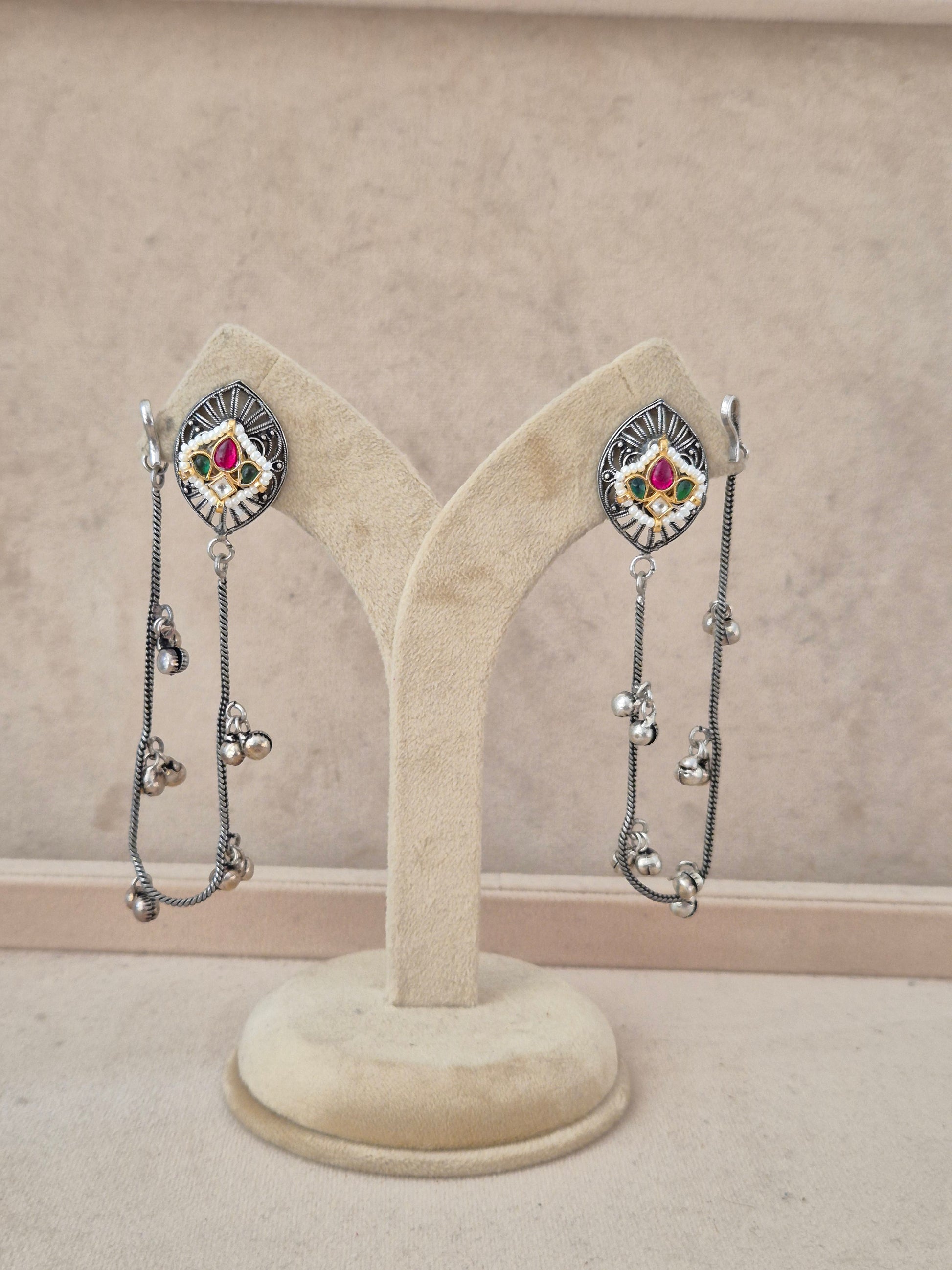 Handcrafted oxidized silver-toned dangle earrings featuring enamel stone studs and long hanging silver chain tassels with ghungroo beads