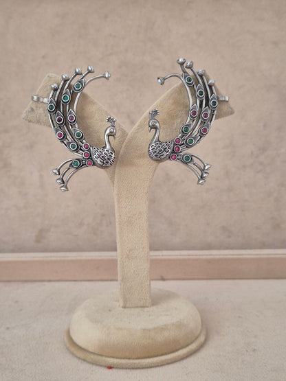 Ethnic oxidized silver peacock statement earrings with pink and green stone details