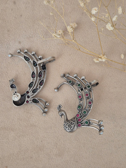 Naitri Bhanuja Earrings in handcrafted oxidized silver alloy featuring a detailed peacock motif and colorful stone work