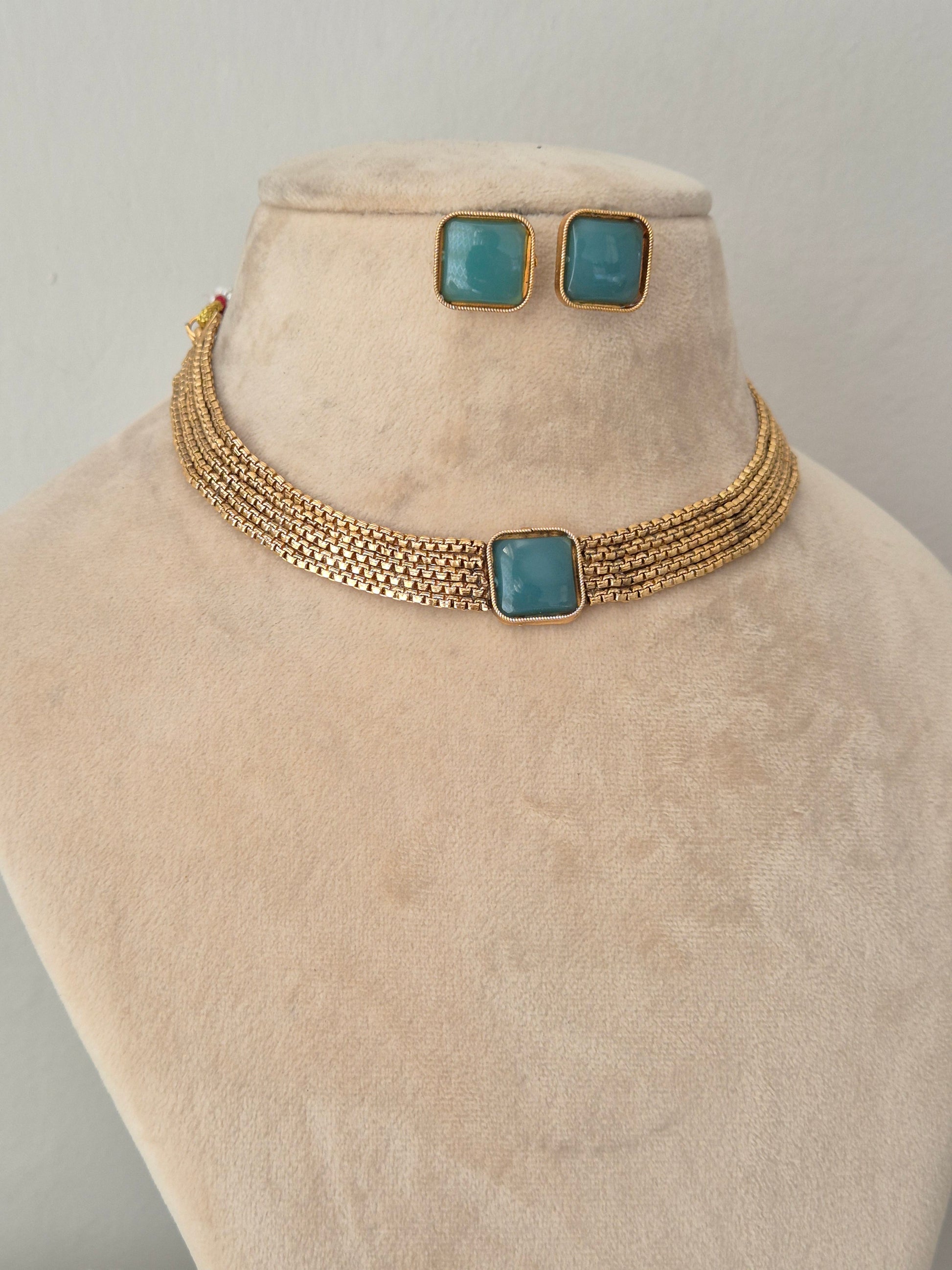 Modern Indian ethnic gold-plated choker set with a square teal stone center and matching square stud earrings