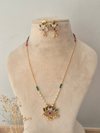 Naitri Luvina Necklace Set – Ethnic gold-plated chain necklace with a multi-colored stone lotus pendant and matching lotus-motif stud earrings