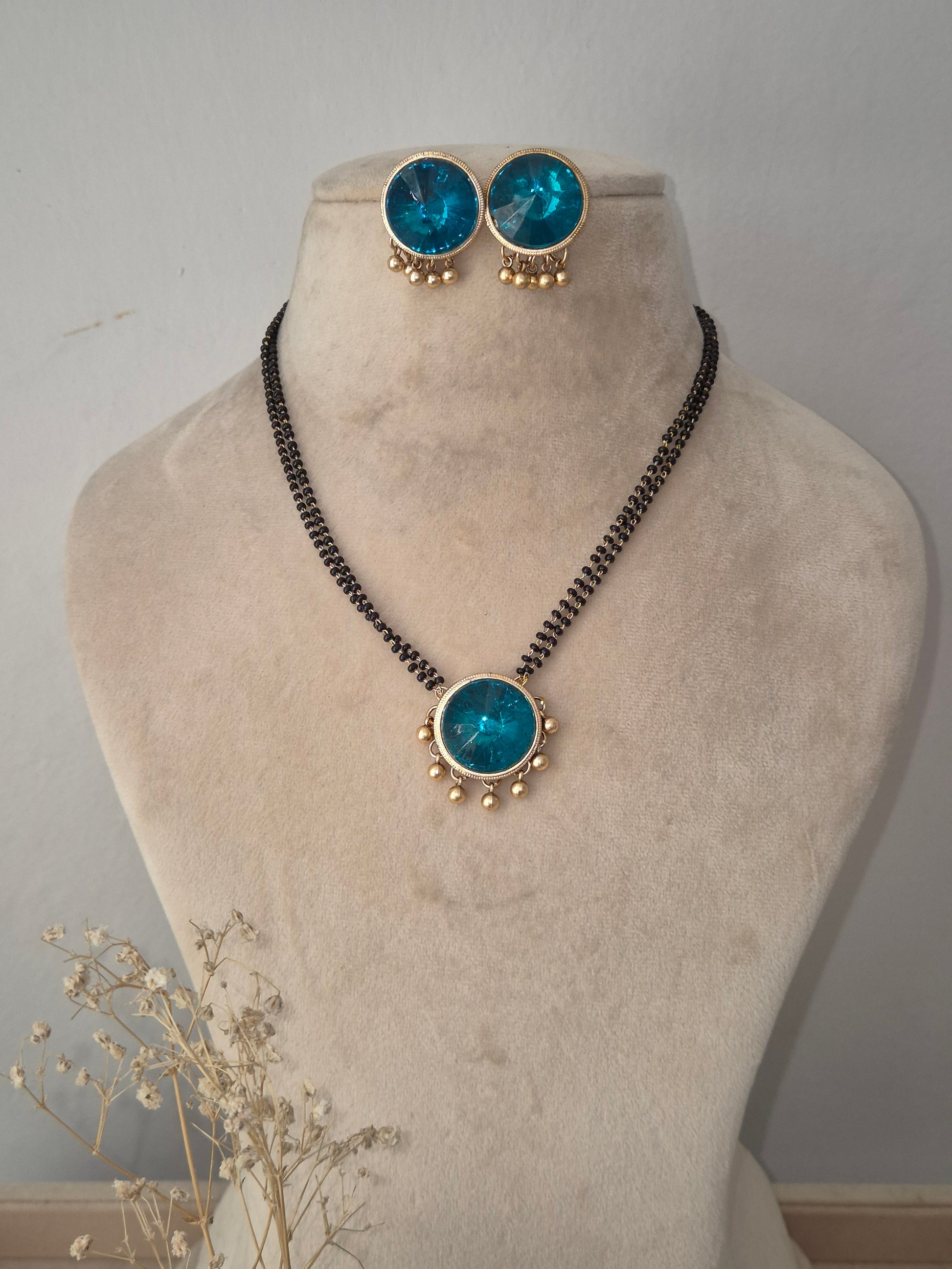 Traditional Preyasi Mangalsutra set with a circular turquoise stone pendant, matching stud earrings, and black-beaded chain