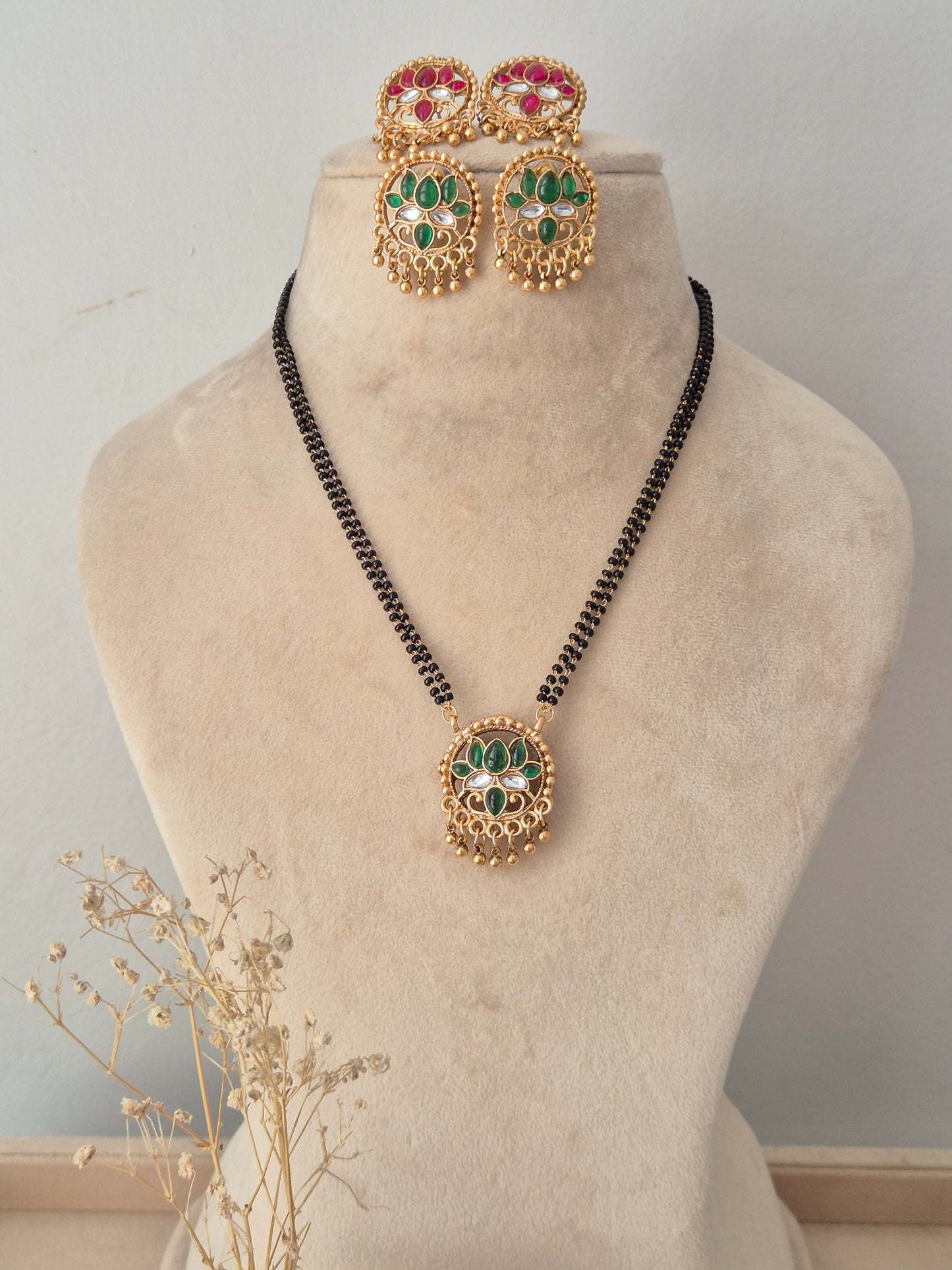 Traditional Reversible Ladita Mangalsutra set featuring a circular green and pink stone pendant, matching earrings, and a black-beaded chain