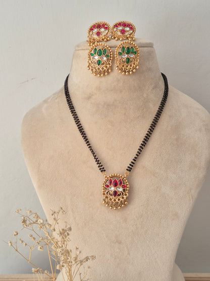 Traditional Reversible Ladita Mangalsutra set featuring a circular red and gold pendant, matching earrings, and a black-beaded chain