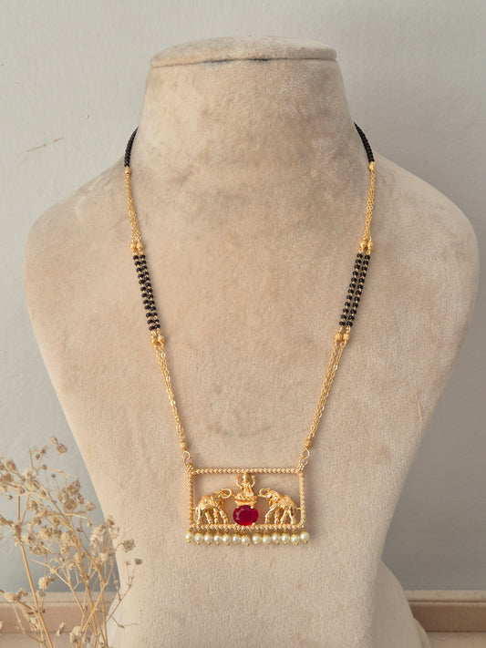 Traditional gold Jivinta Mangalsutra with an ornate rectangular elephant motif pendant, red stone, pearl drops, and black-beaded chain