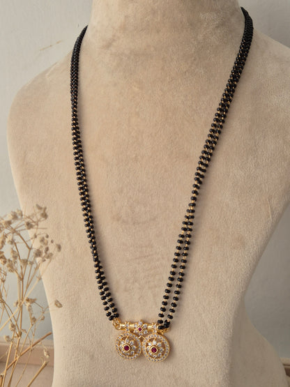 Balaka Mangalsutra featuring a fine double-strand black bead chain connected to a delicate gold floral motif pendant