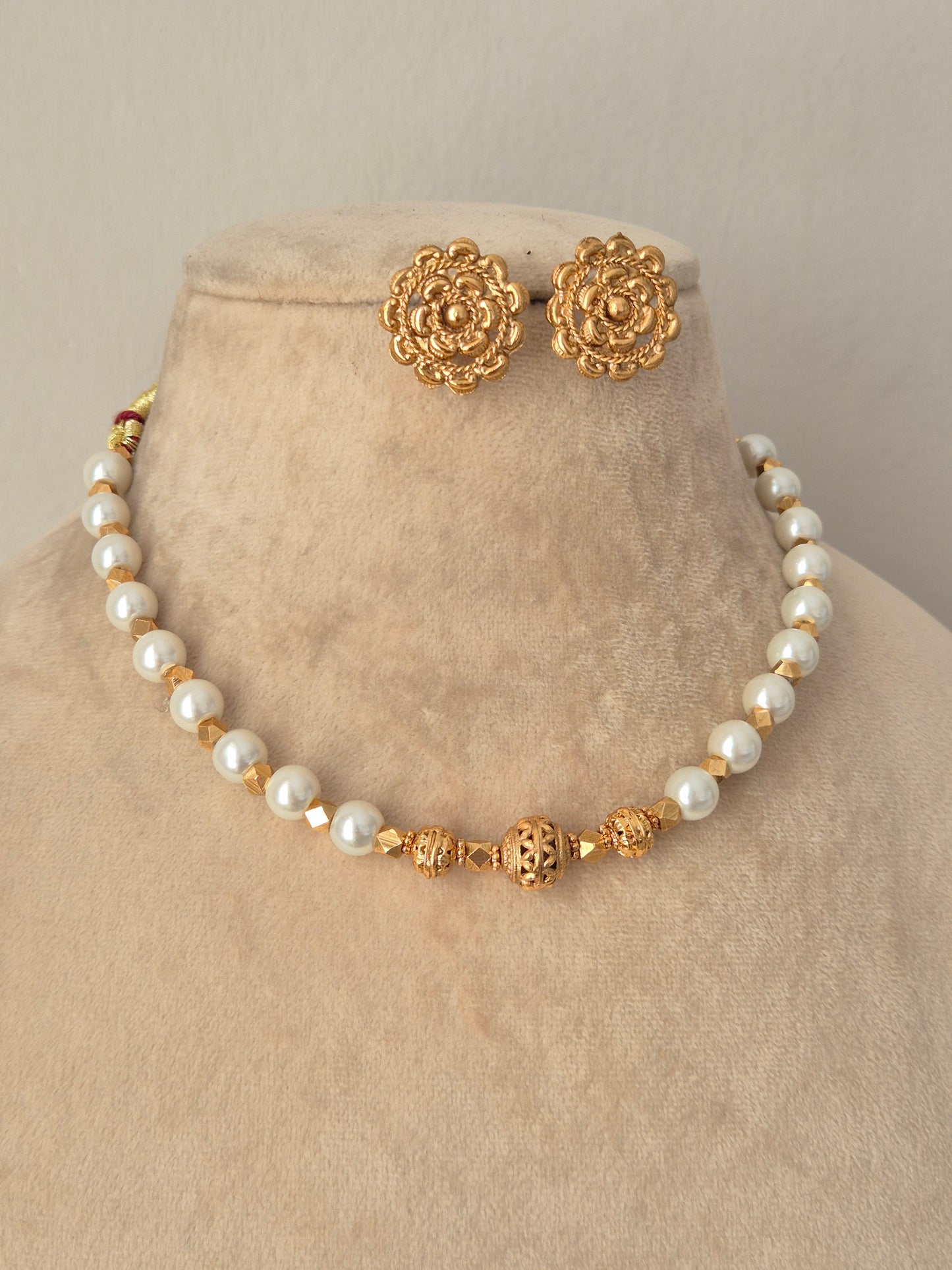 Bhoomija Necklace Set gold pearl choker with carved gold beads and matching floral stud earrings by Naitri