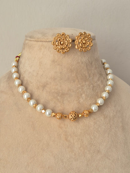 Bhoomija Necklace Set gold pearl choker with carved gold beads and matching floral stud earrings by Naitri
