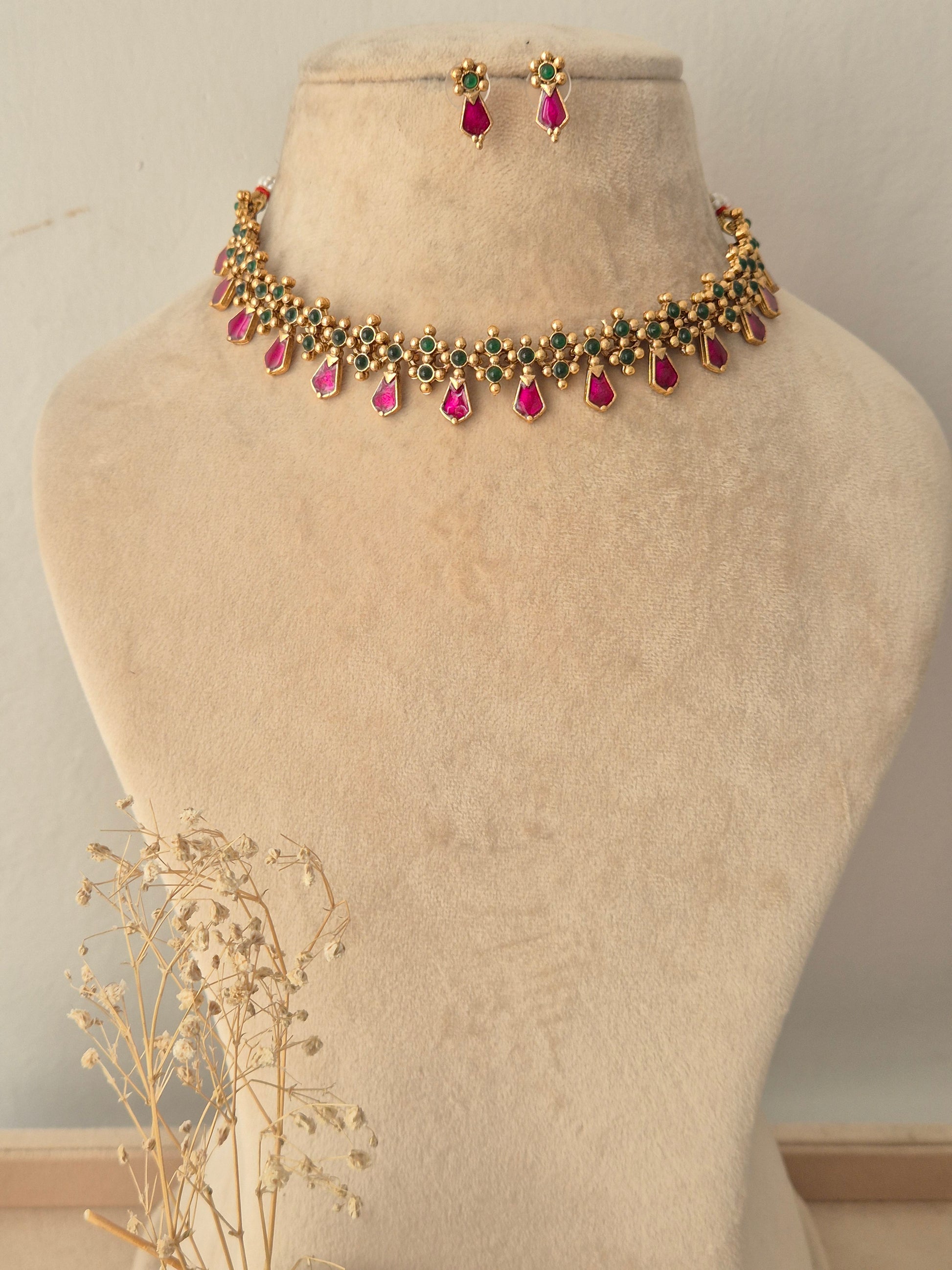 Jamini Necklace Set featuring a gold choker with pink teardrop stones and green accents, paired with matching drop earrings