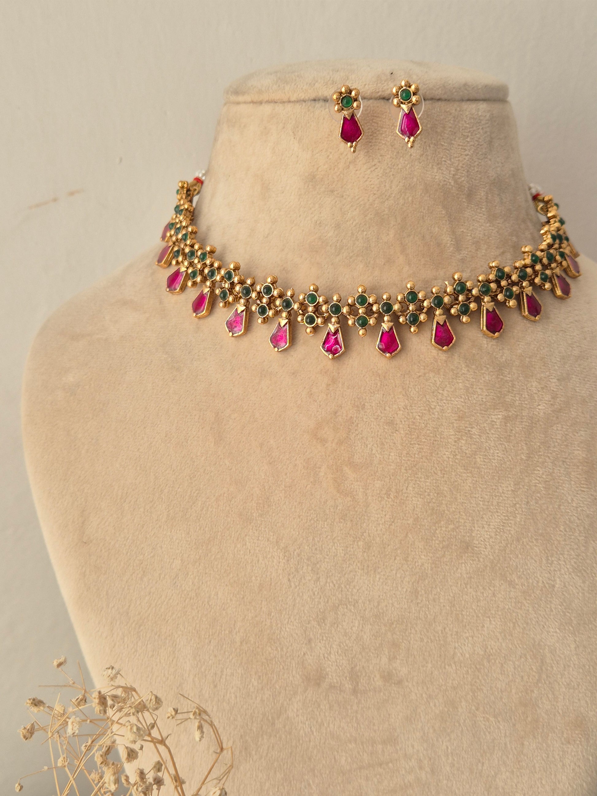 Jamini Necklace Set gold choker with pink teardrop stones, green bead accents, and matching drop earrings by Naitri