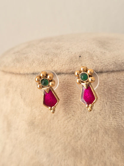 Close-up view of the Jamini gold choker necklace with pink teardrop stones and green bead accents