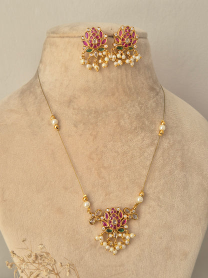 Ludhika Necklace Set gold lotus floral pendant with pink and green stones, pearl drops, and matching earrings by Naitri