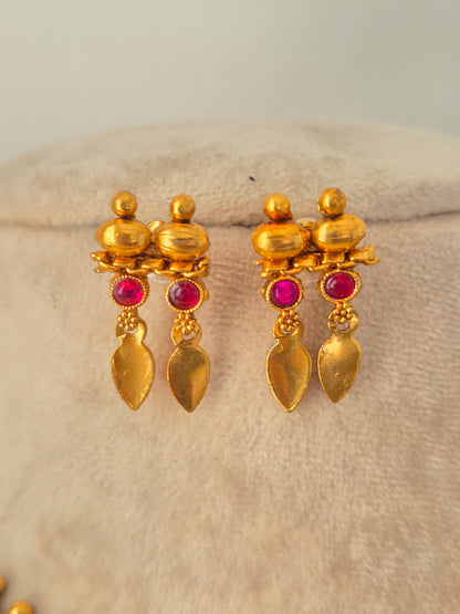 Pair of antique gold drop earrings with pink stones and dangling leaf charms from the Pahal Necklace Set.