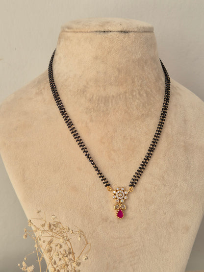 Sitika Mangalsutra gold floral CZ pendant with pink teardrop stone and black bead chain by Naitri.