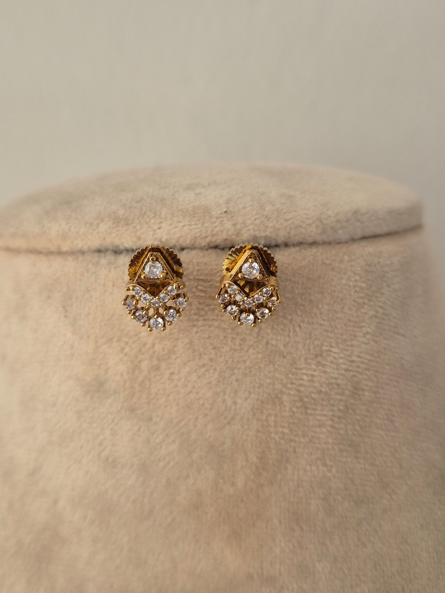 Pair of gold floral CZ stud earrings matching the Ishrat Invisible Necklace Chain Set