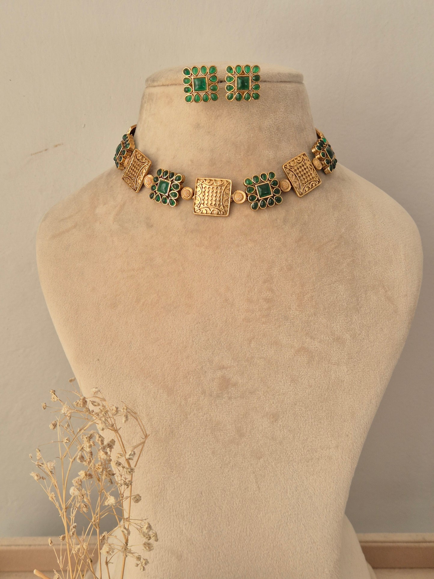 Lambika Necklace Set featuring an antique gold choker with green stone square motifs and matching stud earrings