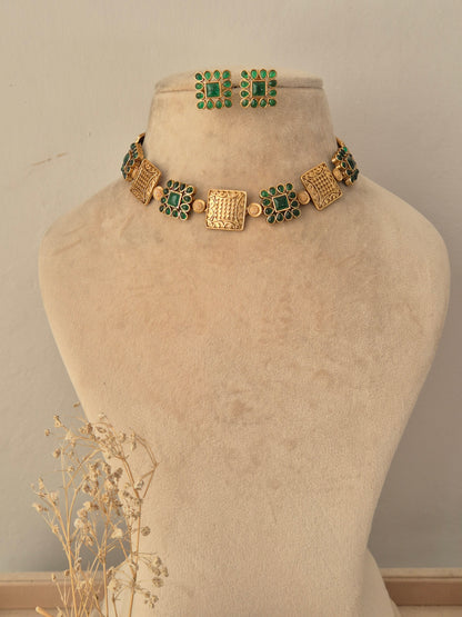 Lambika Necklace Set featuring an antique gold choker with green stone square motifs and matching stud earrings