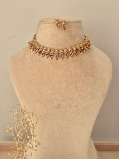 Antique gold choker necklace set with ruby-pink stone accents and matching stud earrings