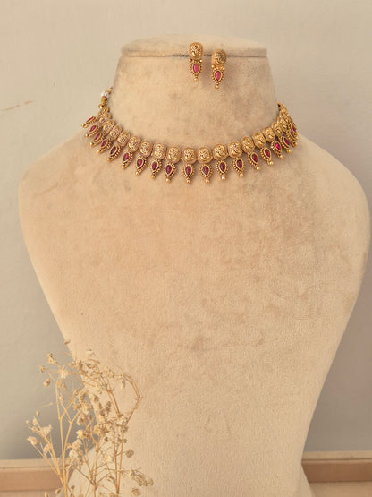 Traditional antique gold choker necklace set with ruby-pink stone accents and matching stud earrings