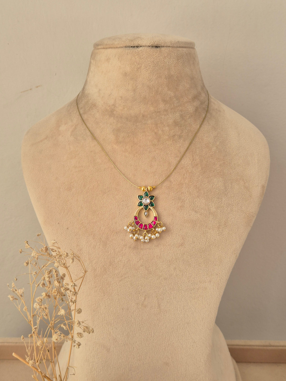 Antique gold traditional jewelry set including a choker necklace, dangling drop earrings, and a maang tikka with ruby-pink stone accents