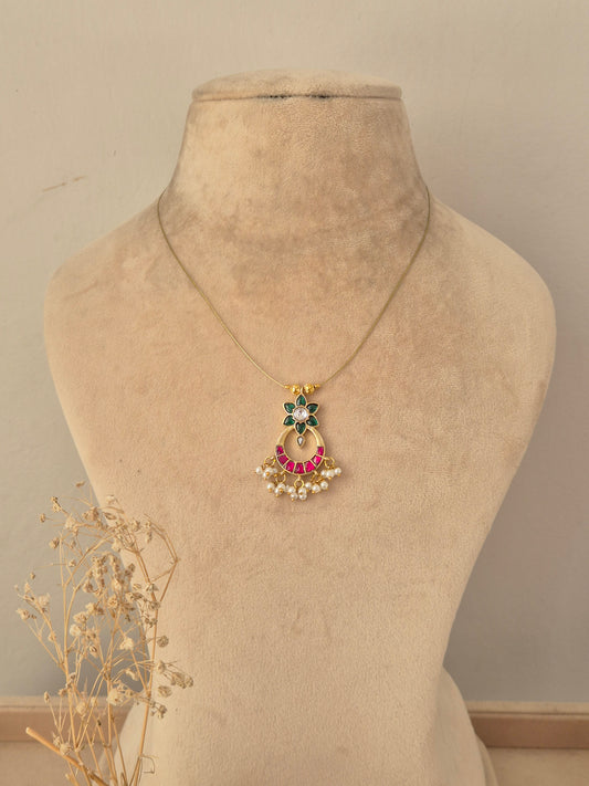 Antique gold traditional jewelry set including a choker necklace, dangling drop earrings, and a maang tikka with ruby-pink stone accents