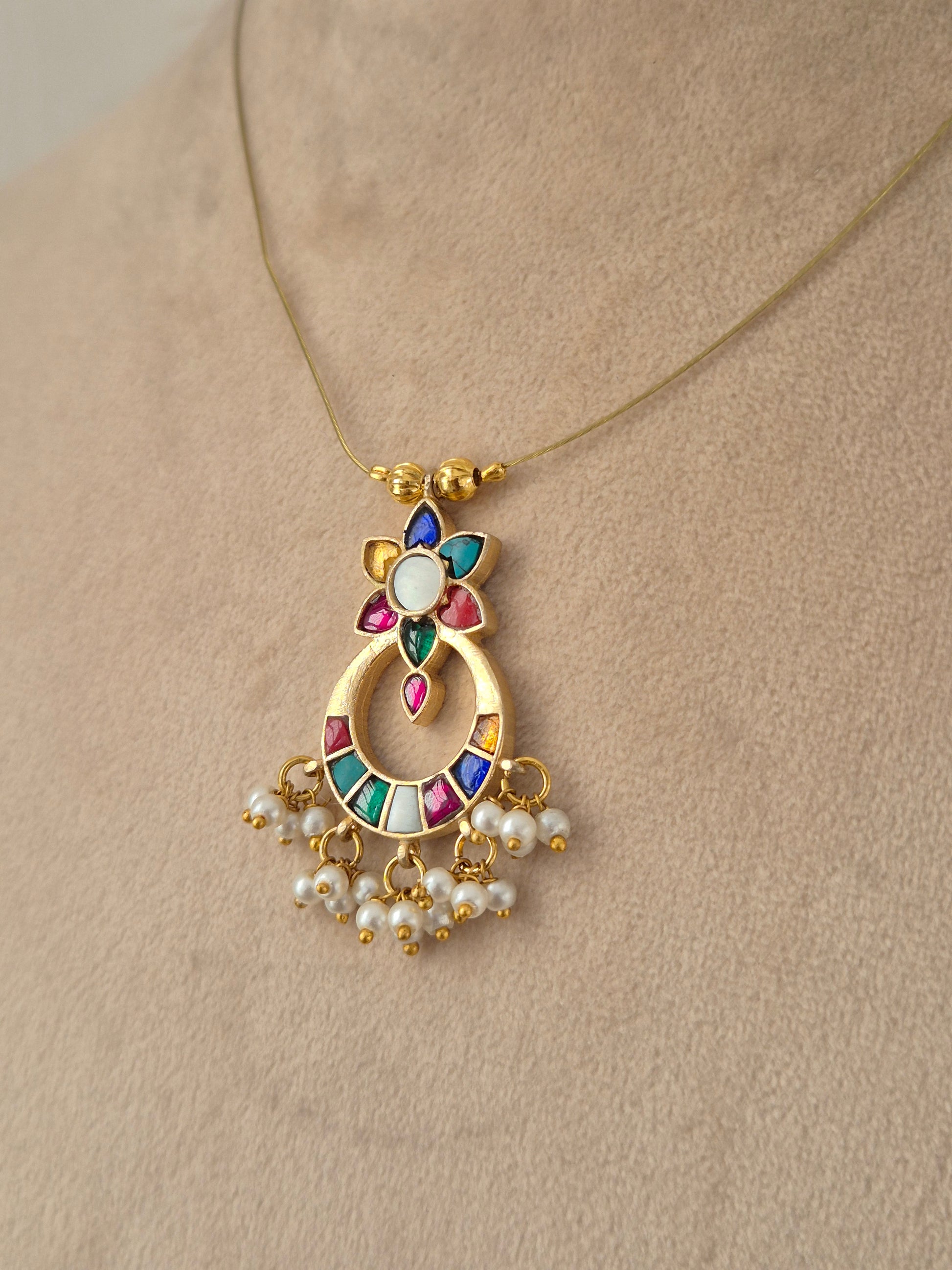 Detailed front view of an antique gold choker set featuring floral cluster accents, ruby-pink teardrop stones, and matching round stud earrings