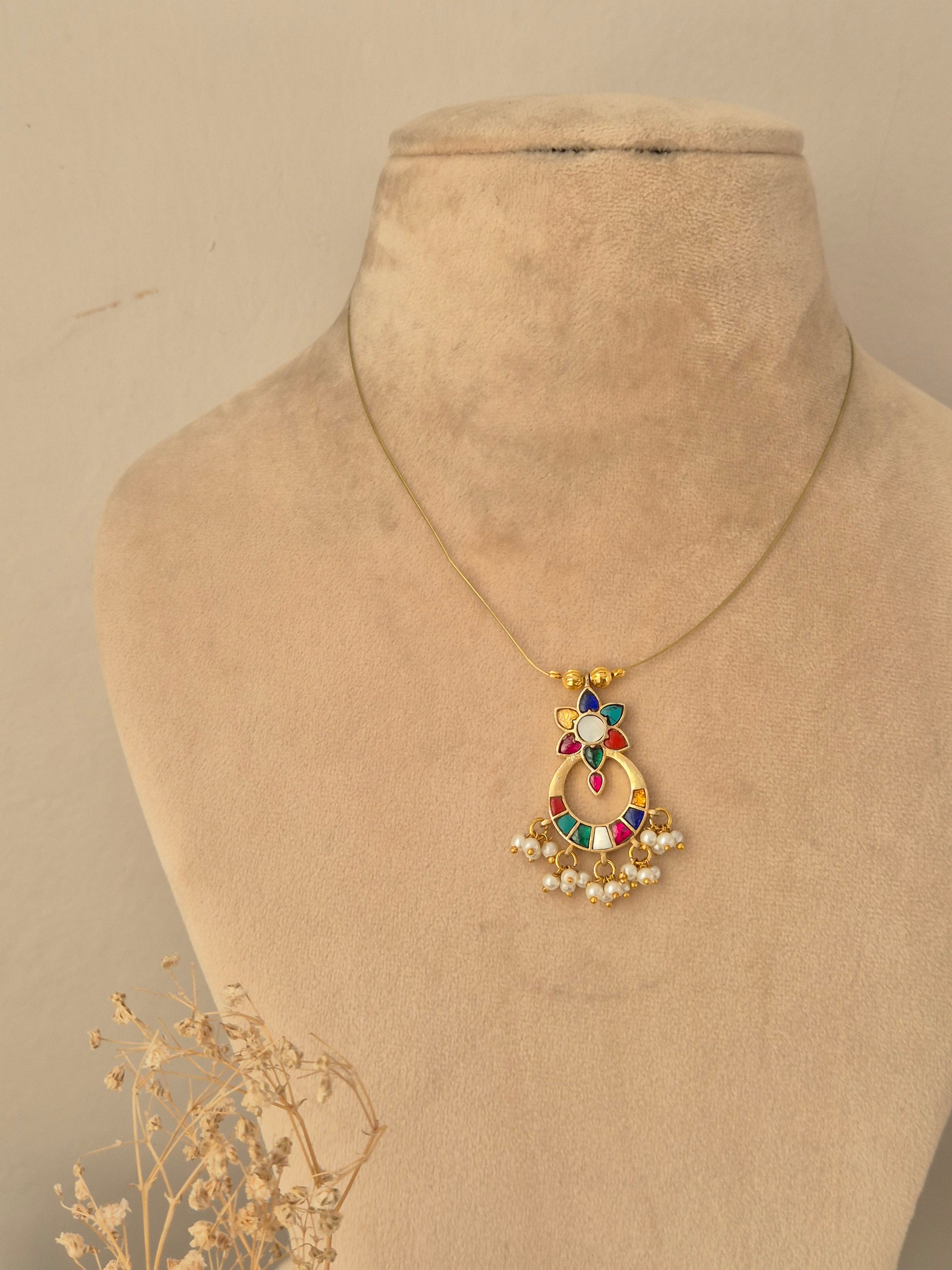 Detailed front view of an antique gold wide choker necklace set featuring intricate scrollwork, ruby-pink stone clusters, and matching oval stud earrings