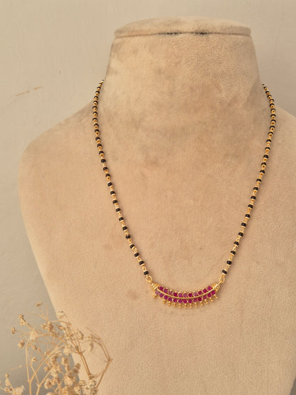 Antique gold-plated long black bead mangalsutra set with ruby-pink stone pendant