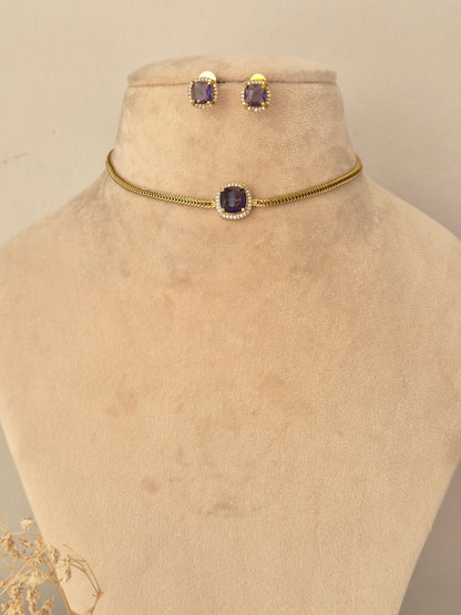 Traditional long mangalsutra with ruby-pink stone accented pendant, black bead chain, and matching stud earrings