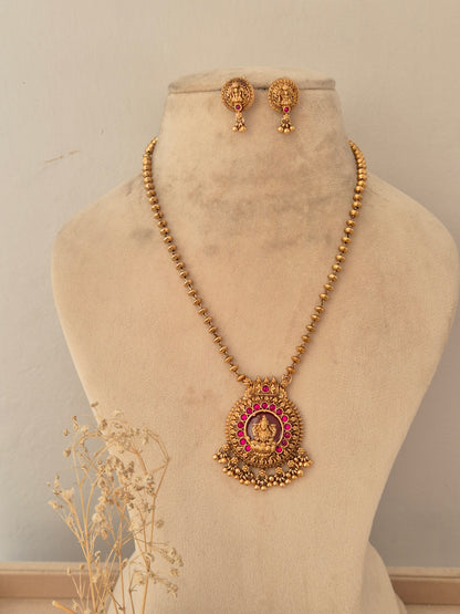 Antique gold-plated round temple earrings with goddess motif, red stone accent, and dangling gold bead clusters
