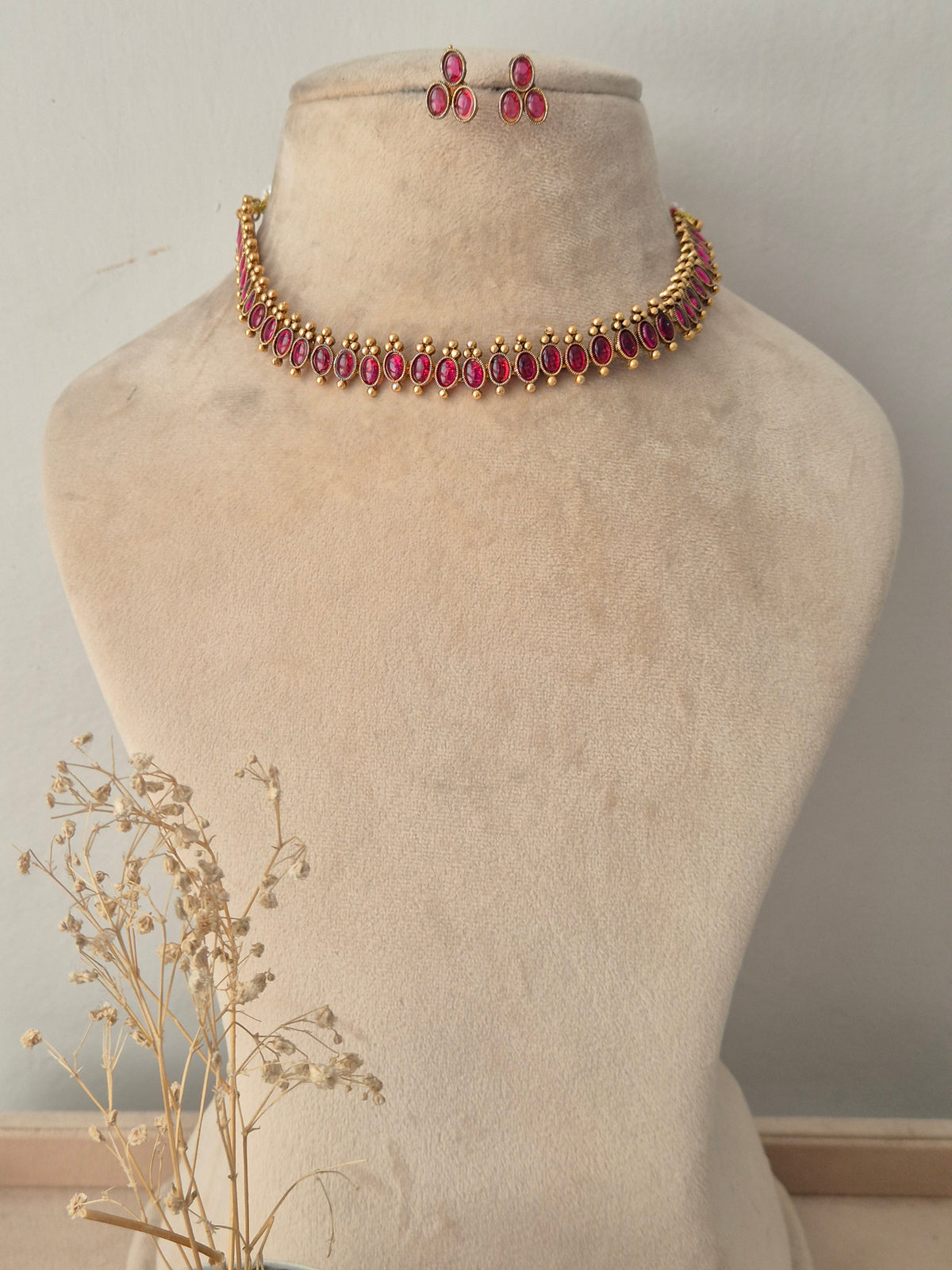 Gold-toned choker necklace set with marquise-cut ruby-pink stones and matching drop earrings