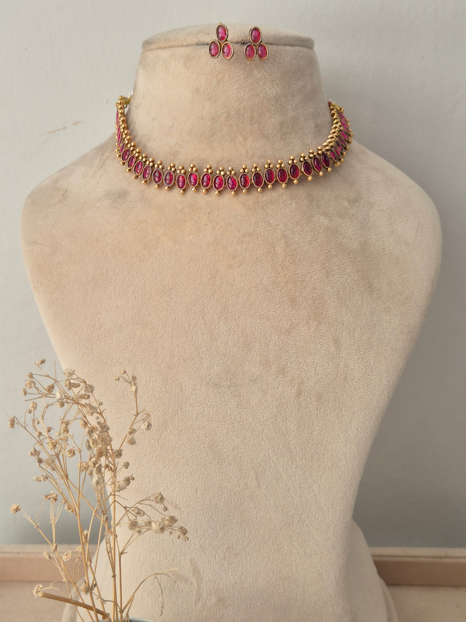 Gold-toned choker necklace set with marquise-cut ruby-pink stones and matching drop earrings