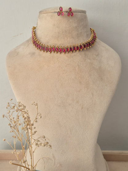 Gold-toned choker necklace set with marquise-cut ruby-pink stones and matching drop earrings