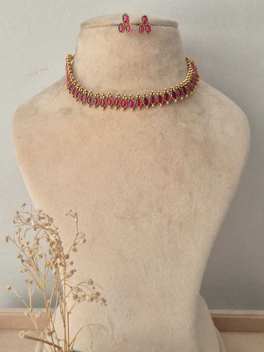 Gold-toned choker necklace set with marquise-cut ruby-pink stones and matching drop earrings