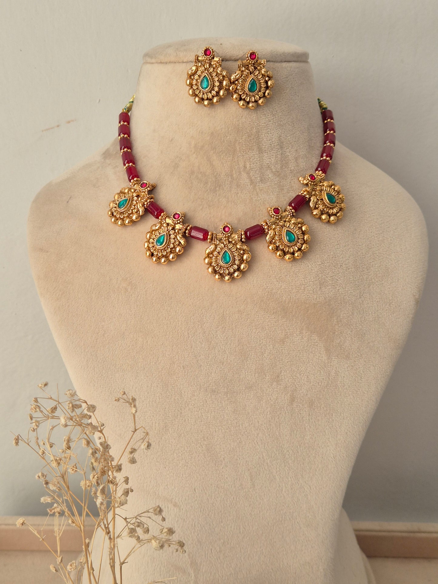 Antique gold necklace set with ruby-red beaded strands, turquoise-green stone drop pendants, and matching stud earrings