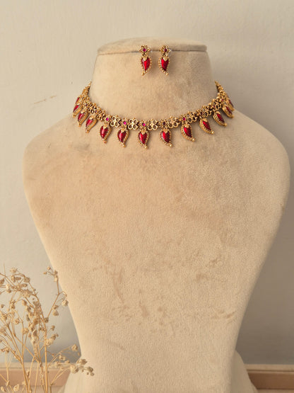 Antique gold choker necklace set with ruby-red teardrop stone accents and matching drop earrings