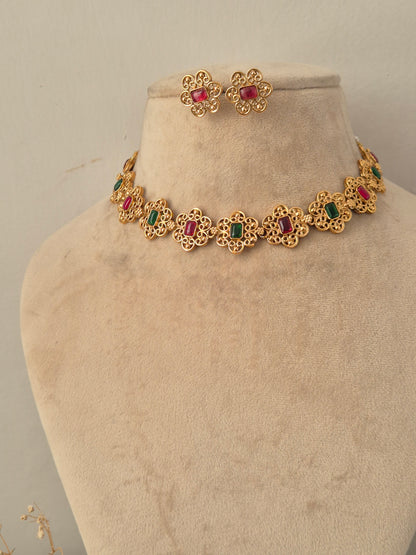Traditional gold filigree floral necklace set with red and green stones and matching stud earrings