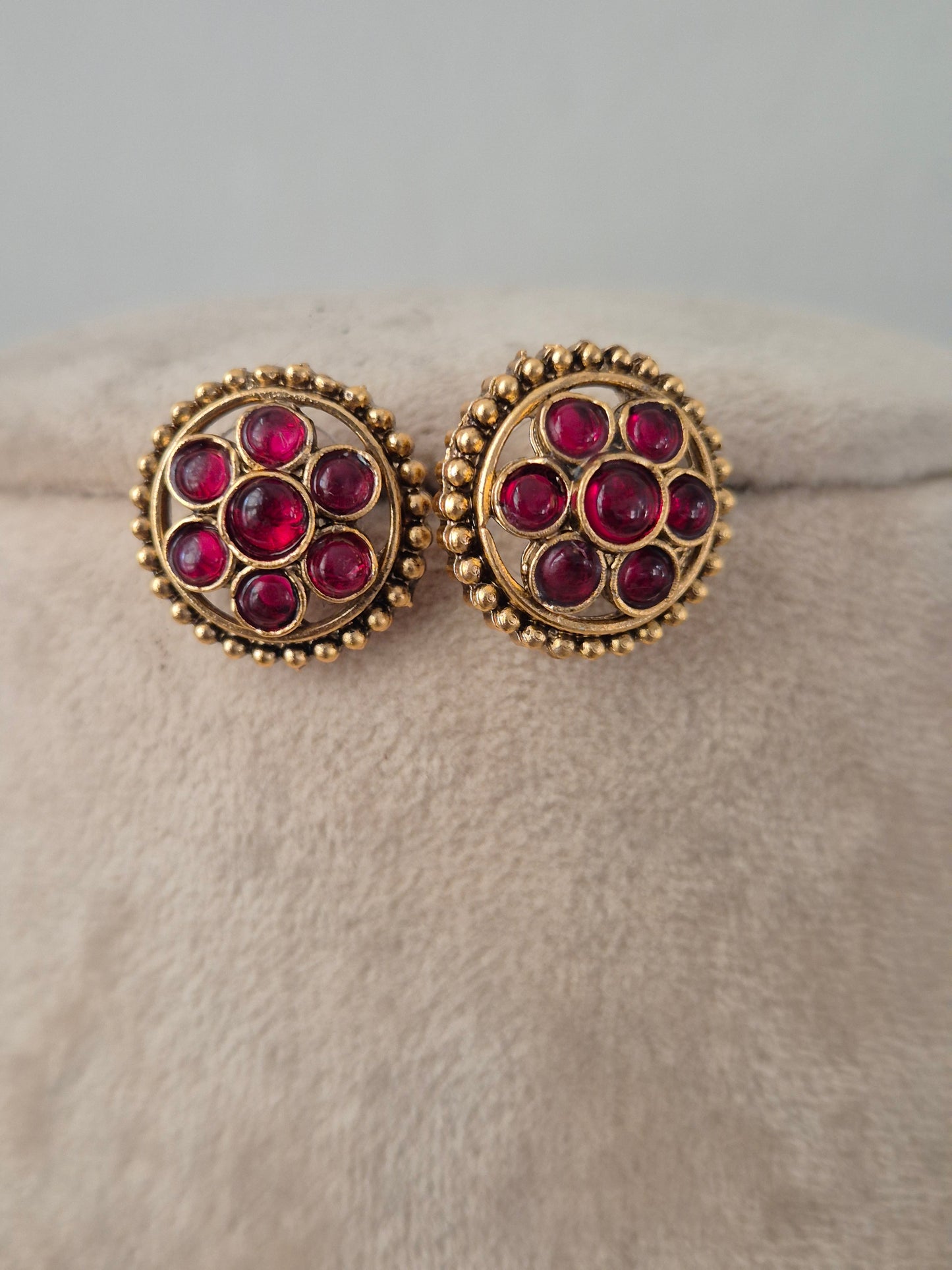 Pair of round antique gold stud earrings set with ruby-pink gemstone clusters